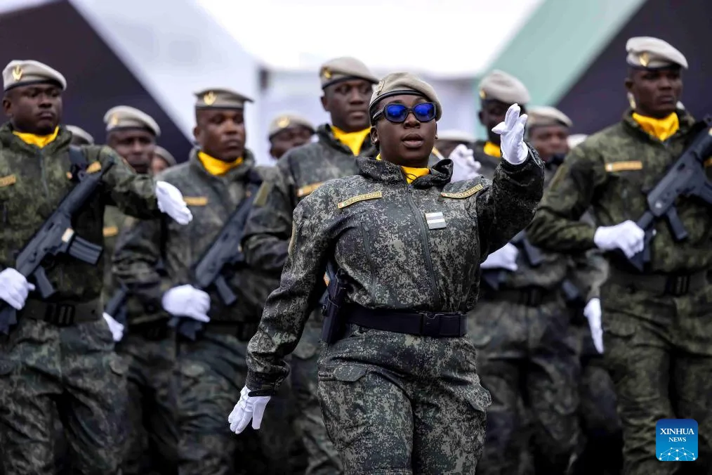 Uniformed personnel carry the Ivorian flag during an Independence Day parade.