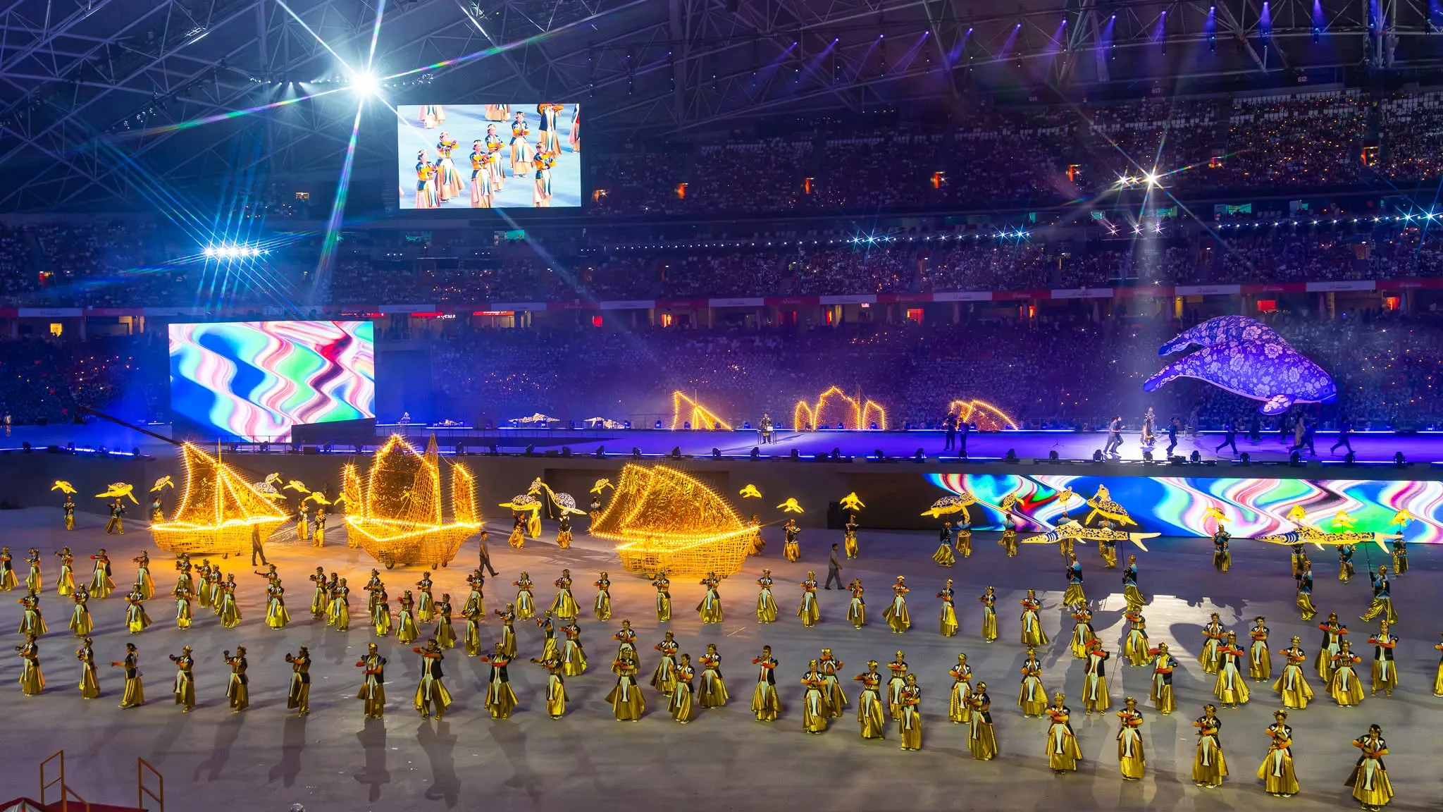 Performers use illuminated props during a National Day Parade show inside Singapore's National Stadium.