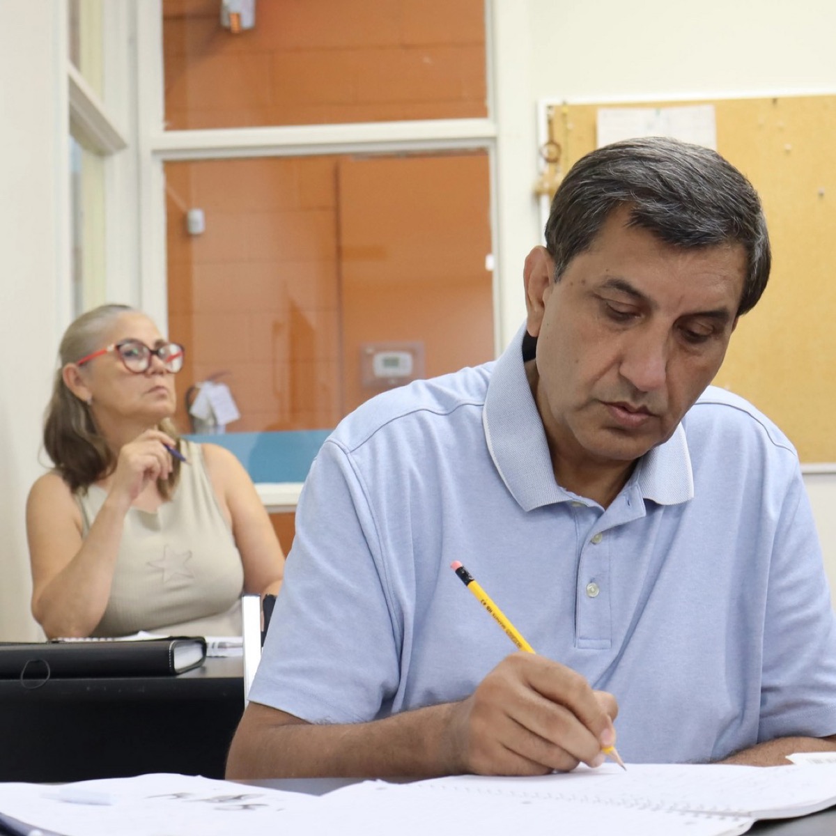 Adults study in a Language Instruction for Newcomers to Canada class.