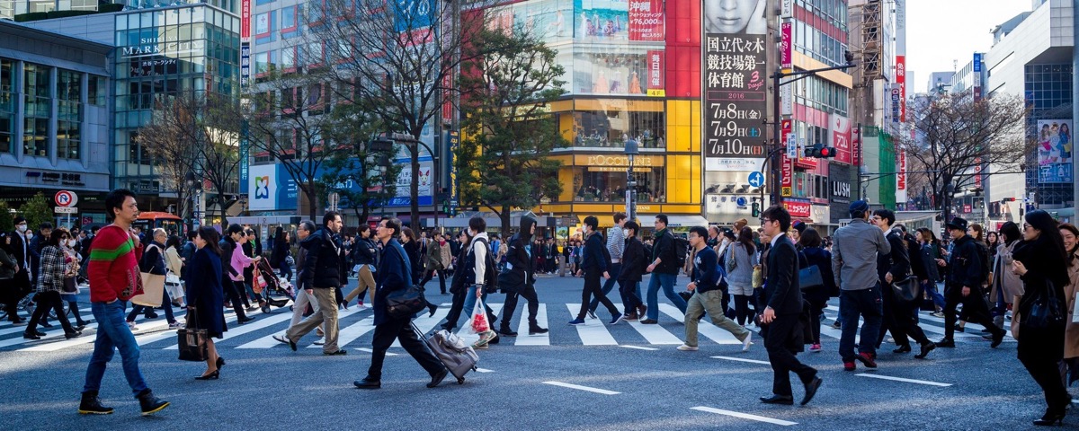 Pedestrians cross a busy street in Tokyo.